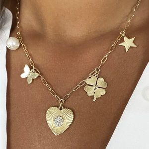 Jennifer Miller gold heart charm necklace.